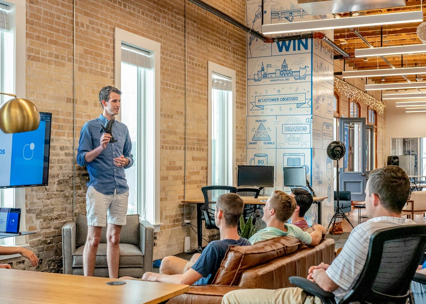 An agency team presenting to colleagues in an office